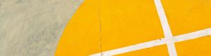White lines on a grey and yellow basketball court